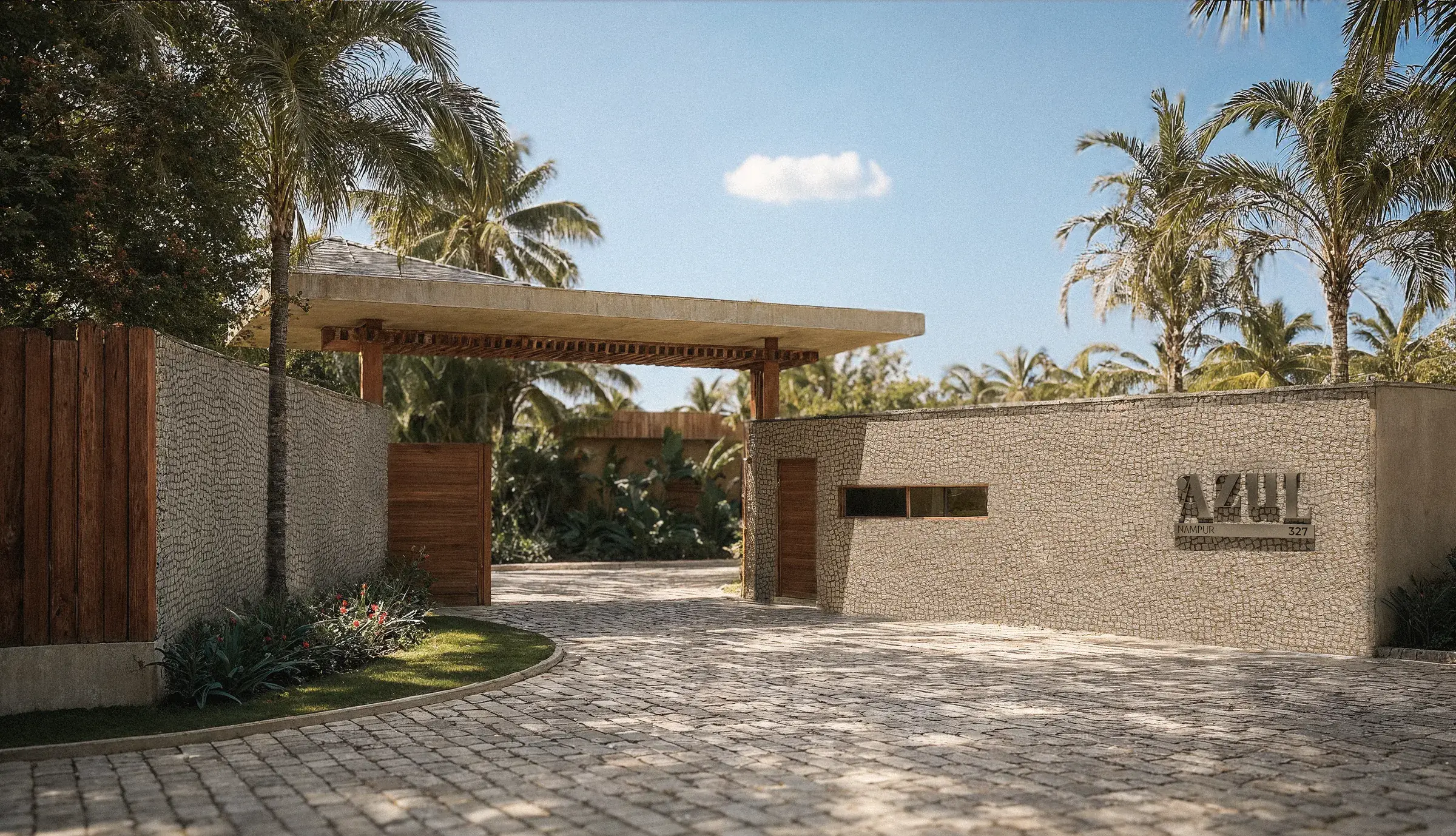 Azul gatehouse with a stone wall, wooden roof and palm trees