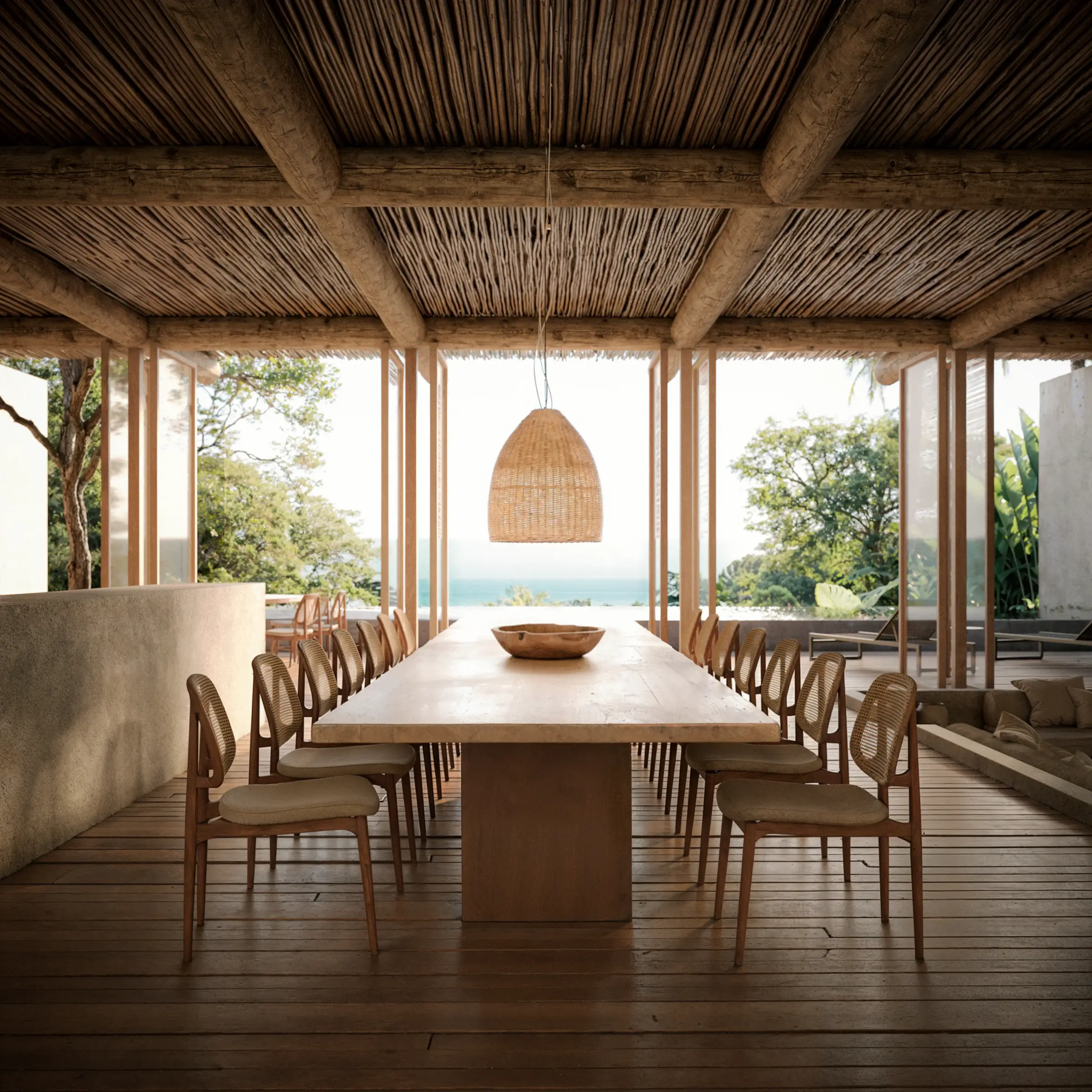 A Mata II dining room with a long wooden table and fibre pendant lamp