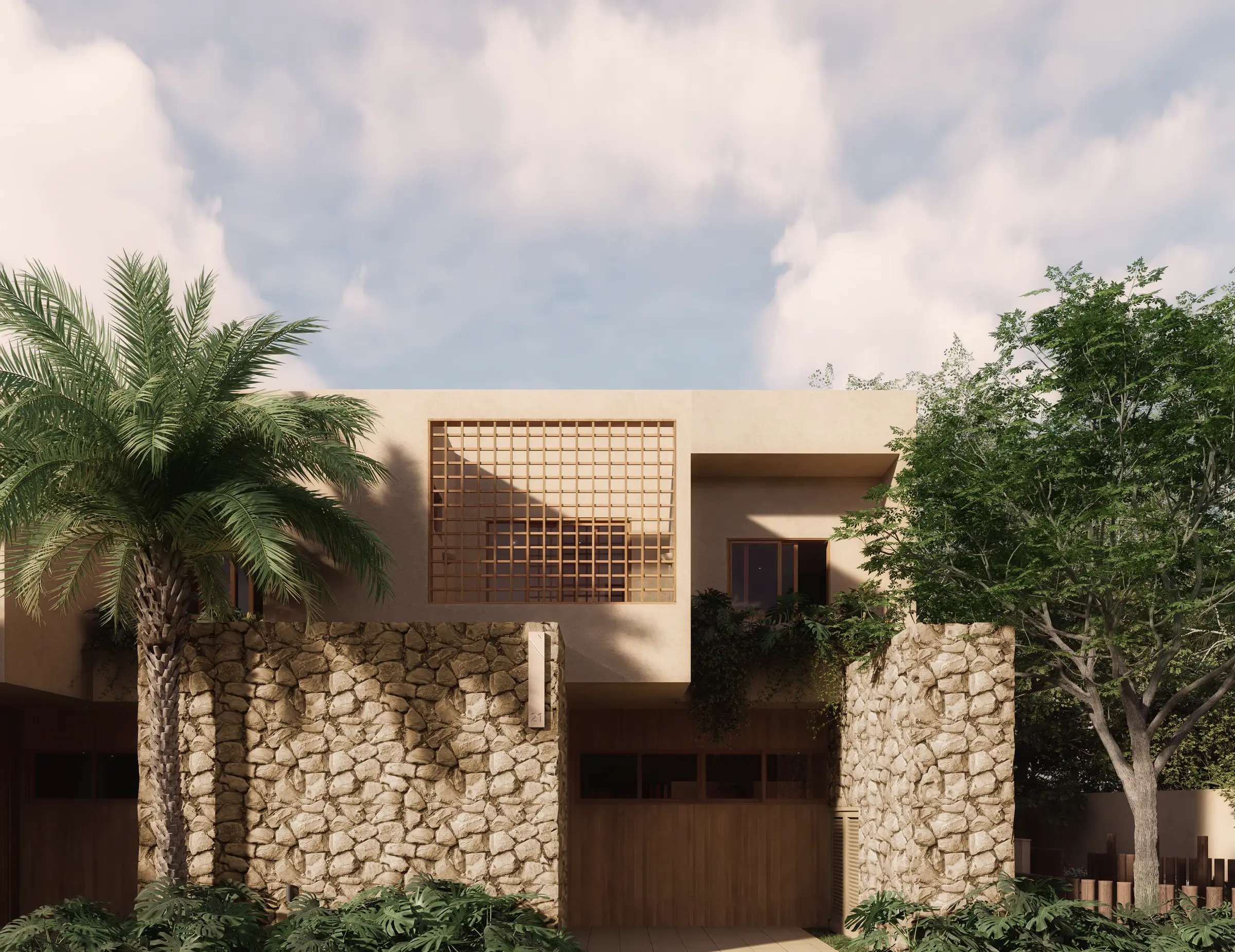 House with stone walls, a wooden entrance and a geometric window on the upper floor, surrounded by palms and tropical planting.