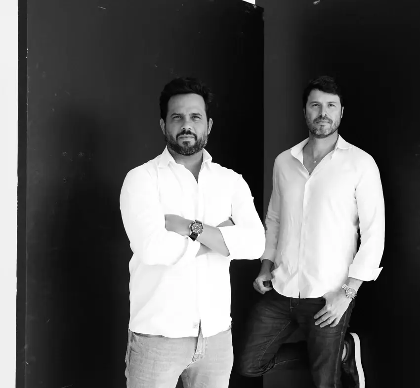 Caio Bandeira and Thiago Martins, Brisa's architects, full-length, in black and white